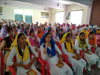 Students listening attentively to the speaker. 