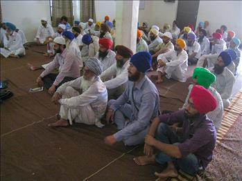 Farmers listening carefully to the views of the speaker.