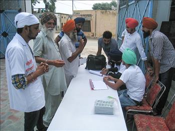 Farmers and volunteers at the registration desk.