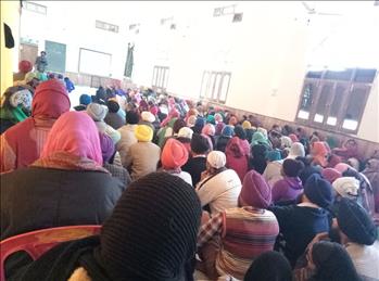 Jampacked hall with a large number of attendees.