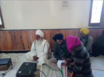 Dr. Varinderpal Singh discussing some point with fellow member.