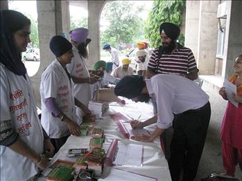 Attendees filling up their registration form at registration counter