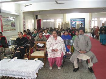 The dignitaries attentively listening to the displayed video