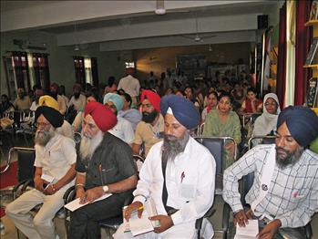 The dignitaries attentively listening to the honorable speaker.