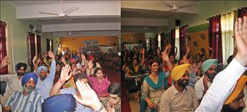 Teachers and participants showing consent by raising their hand on the views of Dr. Varinderpal Singh.