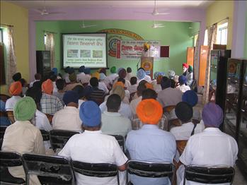 A farmer having some clarifications during Leaf Colour Chart Awareness Campaign.