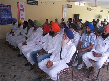 Farmers listening sensibly to the orator.