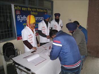 Attendees registering themselves at the registration desk.